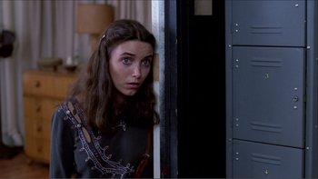 Movie still from “Cruising” (1980), directed by William Friedkin – A woman with long brown hair is looking at the camera; Close Up shot, Low angle