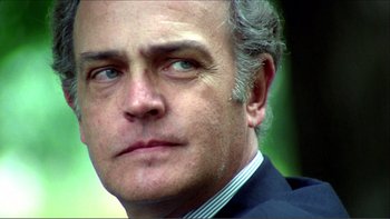 Movie still from “Cruising” (1980), directed by William Friedkin – A person wearing a suit and tie; Close Up shot, Low angle