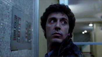 Movie still from “Cruising” (1980), directed by William Friedkin – A person wearing a black jacket; Close Up shot, Low angle