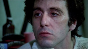 Movie still from “Cruising” (1980), directed by William Friedkin – A man's face with tears in his eyes; Close Up shot, Low angle