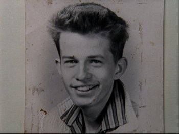 Movie still from “Crumb” (1994), directed by Terry Zwigoff – An old black and white photo of a young man; Extreme Close Up shot, Overhead angle