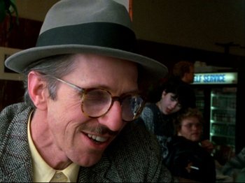Movie still from “Crumb” (1994), directed by Terry Zwigoff – An older man wearing glasses and a hat; Close Up shot, Low angle