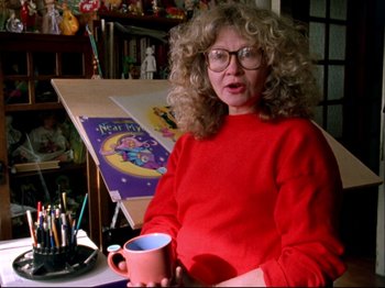 Movie still from “Crumb” (1994), directed by Terry Zwigoff – A woman in a red shirt holding a mug; Close Up shot, Low angle