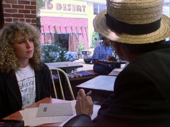 Movie still from “Crumb” (1994), directed by Terry Zwigoff – Two people sitting at an outdoor restaurant table; Medium shot, Over the shoulder angle