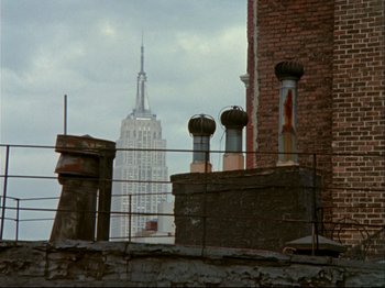 Movie still from “Crumb” (1994), directed by Terry Zwigoff – The empire state building looms in the distance; Wide shot, Low angle