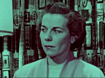 Movie still from “Crumb” (1994), directed by Terry Zwigoff – An old photo of an older woman in front of a wall; Close Up shot, Low angle