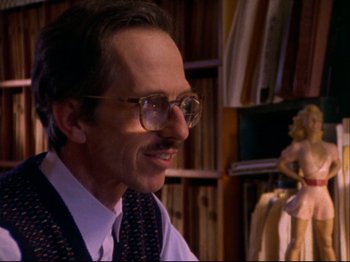 Movie still from “Crumb” (1994), directed by Terry Zwigoff – A person wearing glasses and a tie; Close Up shot, Low angle