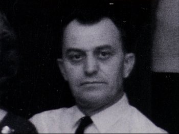 Movie still from “Crumb” (1994), directed by Terry Zwigoff – An old photo of a man in a dress shirt and tie; Close Up shot, Low angle