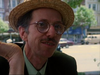 Movie still from “Crumb” (1994), directed by Terry Zwigoff – A person wearing glasses and a straw hat; Close Up shot, Low angle
