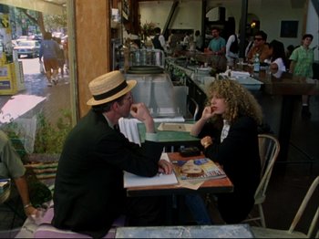 Movie still from “Crumb” (1994), directed by Terry Zwigoff – A man and a woman are sitting at a table; Wide shot, Over the shoulder angle