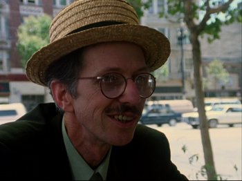 Movie still from “Crumb” (1994), directed by Terry Zwigoff – A man wearing a straw hat and glasses; Close Up shot, Low angle