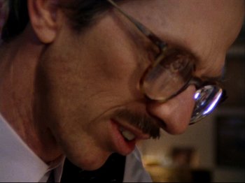 Movie still from “Crumb” (1994), directed by Terry Zwigoff – A person wearing glasses; Extreme Close Up shot, Low angle