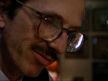Movie still from “Crumb” (1994), directed by Terry Zwigoff – A person wearing glasses; Extreme Close Up shot, Low angle