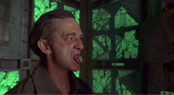 Movie still from “Cube” (1997), directed by Vincenzo Natali – A person with a cigarette in his mouth; Close Up shot, Low angle