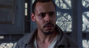 Movie still from “Cube” (1997), directed by Vincenzo Natali – A person with a beard; Close Up shot, Low angle