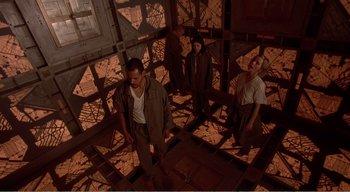 Movie still from “Cube” (1997), directed by Vincenzo Natali – A group of people standing around in a room; Wide shot, High angle