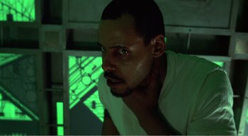 Movie still from “Cube” (1997), directed by Vincenzo Natali – A person wearing a white t - shirt; Close Up shot, Low angle