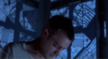 Movie still from “Cube” (1997), directed by Vincenzo Natali – A person looking down at his face; Close Up shot, Low angle