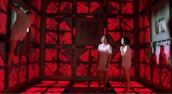 Movie still from “Cube” (1997), directed by Vincenzo Natali – A couple of people that are standing in a room; Wide shot, Low angle