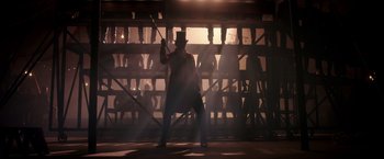 Movie still from “The Greatest Showman” (2017), directed by Michael Gracey – A man holding a baseball bat while standing next to a wall; Wide shot, Low angle