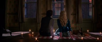 Movie still from “The Greatest Showman” (2017), directed by Michael Gracey – A man and a woman sitting on the floor in front of a window; Medium shot, High angle
