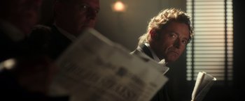 Movie still from “The Greatest Showman” (2017), directed by Michael Gracey – A man in a suit and tie holding a newspaper; Close Up shot, Low angle