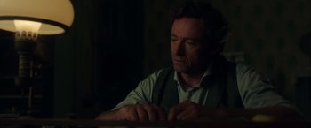 Movie still from “The Greatest Showman” (2017), directed by Michael Gracey – A person sitting at a table; Close Up shot, Over the shoulder angle