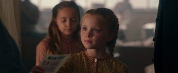 Movie still from “The Greatest Showman” (2017), directed by Michael Gracey – Two young girls are sitting in a dimly lit room; Close Up shot, Over the shoulder angle