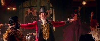 Movie still from “The Greatest Showman” (2017), directed by Michael Gracey – A man wearing a red jacket and a top hat; Medium shot, Low angle