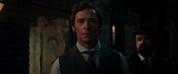 Movie still from “The Greatest Showman” (2017), directed by Michael Gracey – A person wearing a vest and tie; Close Up shot, Low angle