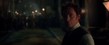 Movie still from “The Greatest Showman” (2017), directed by Michael Gracey – A person wearing a suit and tie; Close Up shot, Over the shoulder angle