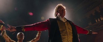 Movie still from “The Greatest Showman” (2017), directed by Michael Gracey – A man dressed in a costume and holding a whip; Medium shot, Low angle