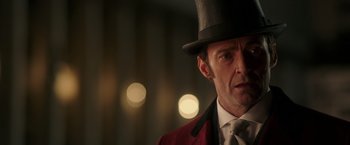 Movie still from “The Greatest Showman” (2017), directed by Michael Gracey – A person wearing a top hat; Close Up shot, Over the shoulder angle