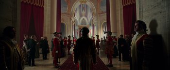 Movie still from “The Greatest Showman” (2017), directed by Michael Gracey – A group of men in red and black suits standing in front of a red carpet; Extreme Wide shot, Low angle