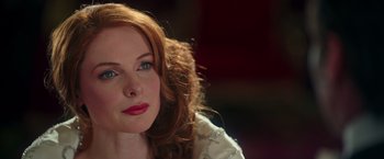 Movie still from “The Greatest Showman” (2017), directed by Michael Gracey – A person with long red curly hair; Close Up shot, Over the shoulder angle