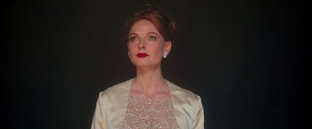 Movie still from “The Greatest Showman” (2017), directed by Michael Gracey – A woman with red hair wearing a white dress and red lipstick; Close Up shot, Low angle