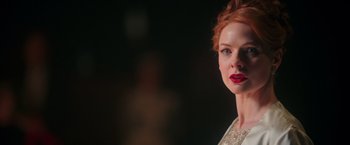 Movie still from “The Greatest Showman” (2017), directed by Michael Gracey – A person with red hair and lipstick; Close Up shot, Low angle