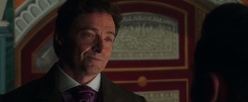 Movie still from “The Greatest Showman” (2017), directed by Michael Gracey – A person wearing a suit and purple tie; Close Up shot, Over the shoulder angle