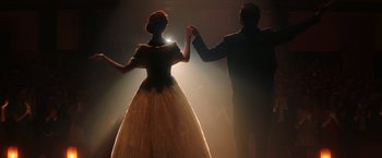 Movie still from “The Greatest Showman” (2017), directed by Michael Gracey – A man and a woman are dancing in the dark; Wide shot, Low angle
