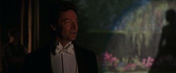 Movie still from “The Greatest Showman” (2017), directed by Michael Gracey – A person wearing a suit and bow tie; Close Up shot, Over the shoulder angle
