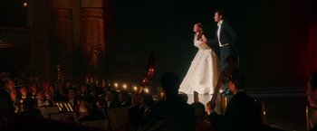 Movie still from “The Greatest Showman” (2017), directed by Michael Gracey – A man and a woman are on a stage with musical instruments; Wide shot, Low angle