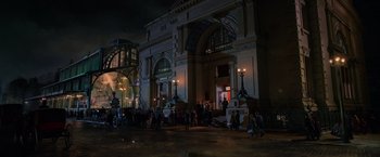 Movie still from “The Greatest Showman” (2017), directed by Michael Gracey – A group of people standing in front of a building at night; Extreme Wide shot, Low angle