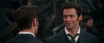 Movie still from “The Greatest Showman” (2017), directed by Michael Gracey – A man in a suit and tie looking at another man in a suit and tie; Close Up shot, Over the shoulder angle