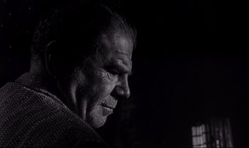 Movie still from “Cul-de-sac” (1966), directed by Roman Polanski – An old man with a beard is looking into the distance; Close Up shot, Low angle