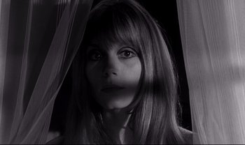 Movie still from “Cul-de-sac” (1966), directed by Roman Polanski – A black and white photo of a woman looking at the camera; Close Up shot, Low angle