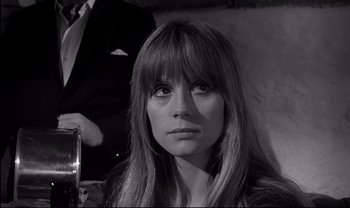 Movie still from “Cul-de-sac” (1966), directed by Roman Polanski – A black and white photo of a woman with long hair; Close Up shot, Over the shoulder angle