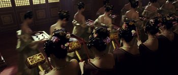 Movie still from “Curse of the Golden Flower” (2006), directed by Yimou Zhang – A group of women in fancy dresses in front of a mirror; Wide shot, High angle