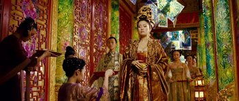Movie still from “Curse of the Golden Flower” (2006), directed by Yimou Zhang – A woman dressed in oriental clothing holding a cup; Medium shot, Over the shoulder angle