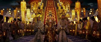 Movie still from “Curse of the Golden Flower” (2006), directed by Yimou Zhang – A group of people standing next to each other in front of a staircase; Wide shot, Low angle