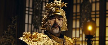 Movie still from “Curse of the Golden Flower” (2006), directed by Yimou Zhang – A man wearing a gold helmet and a gold armor; Close Up shot, Low angle